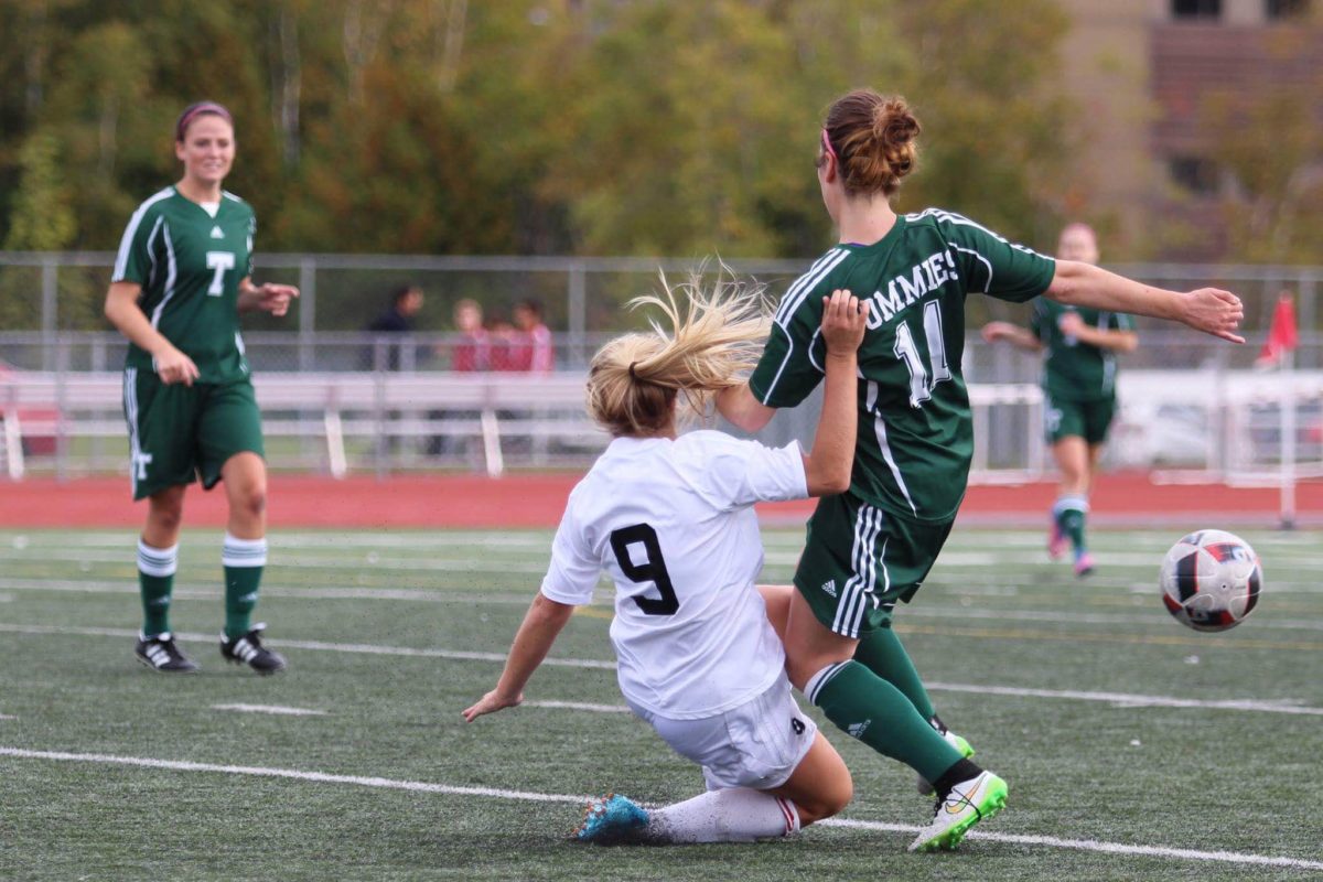Rebecca Reay, 9, of the University of New Brunswick Saint John Seawolves is held off by Chelsey Leahy, 11, of the St. Thomas Tommies in women's soccer action Saturday, Oct. 1 in Saint John. Photo: Chris Robinson/The AQ